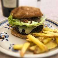 Serveersuggestie Zwartebonenburger met gruyère en gekaramelliseerde uien